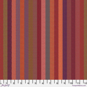 A woven fabric with broad stripes in red, orange, and purple colors, marked with measurements along the edge.