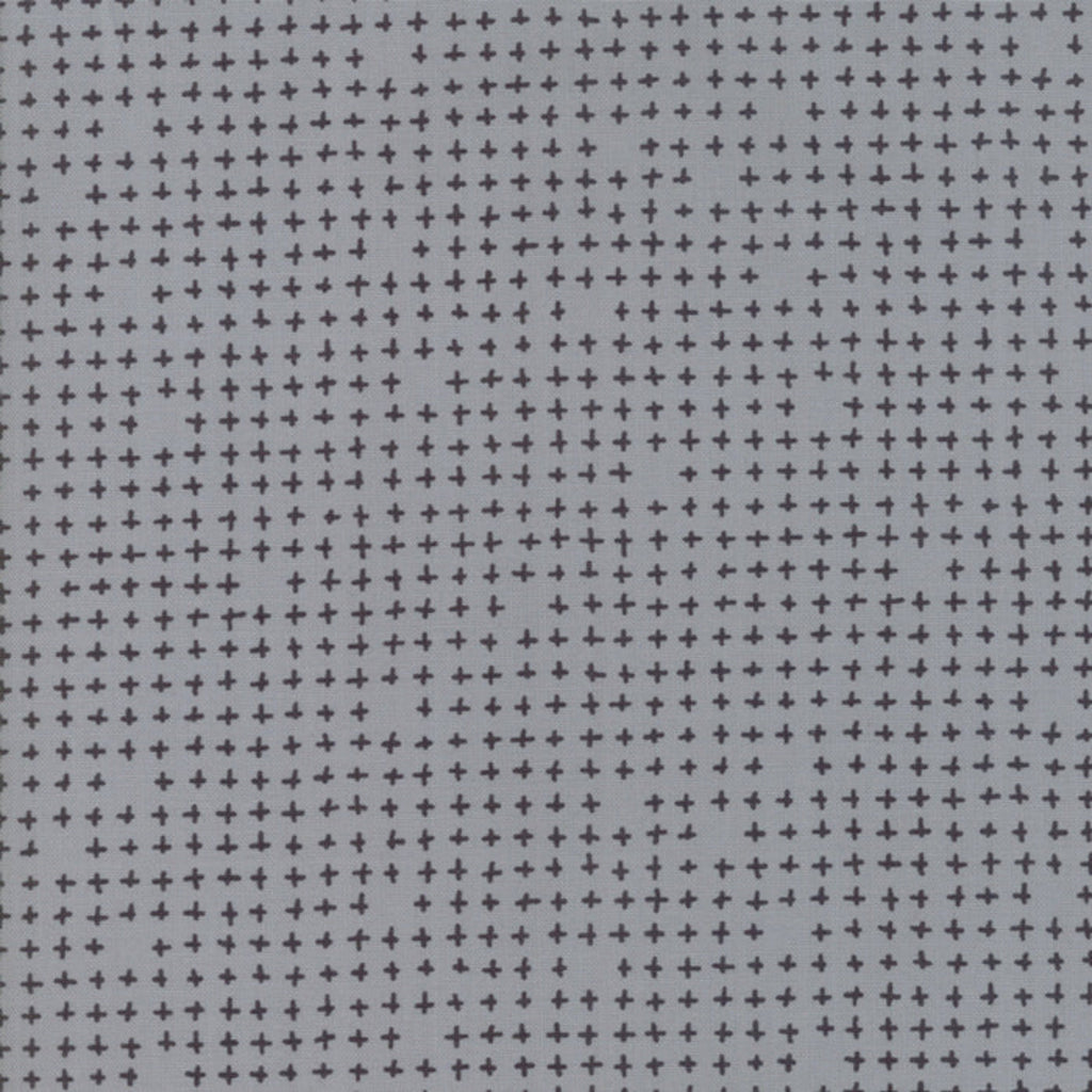 A fabric with a modern geometric cross pattern in a grey color.