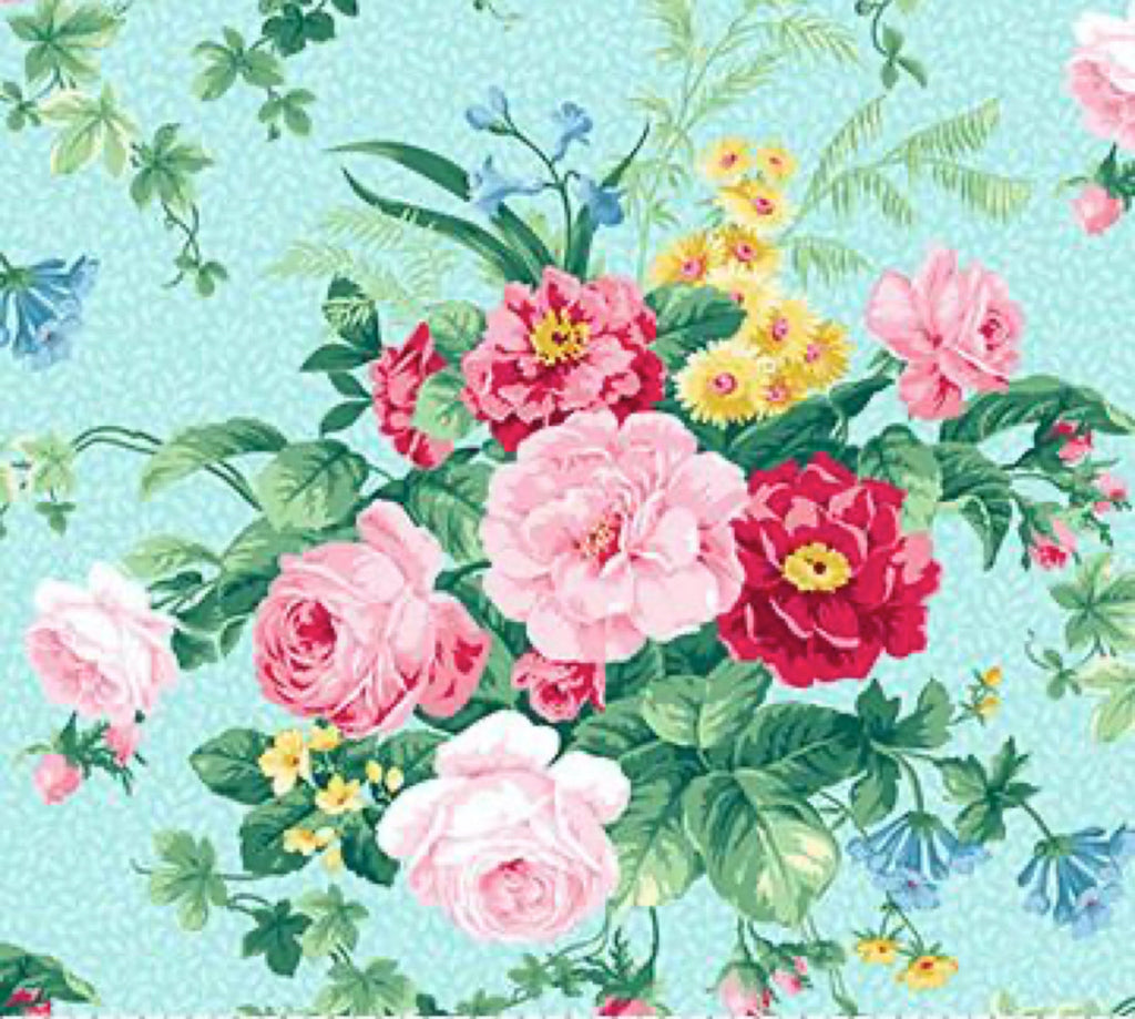A piece of fabric featuring a large floral design with blue flowers, green leaves, and pink accents, from the Julia's Garden collection by Deborah Edwards.