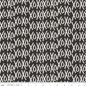 A fabric with a pattern of white Xo's on a black background.
