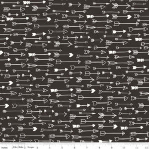 A fabric with a pattern of white arrows on a black background.