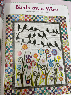 Quilt with floral and bird design on a colorful border, featuring the text 'Birds on a Wire'.