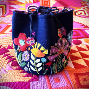 Decorative bag with floral patterns on a colorful quilt