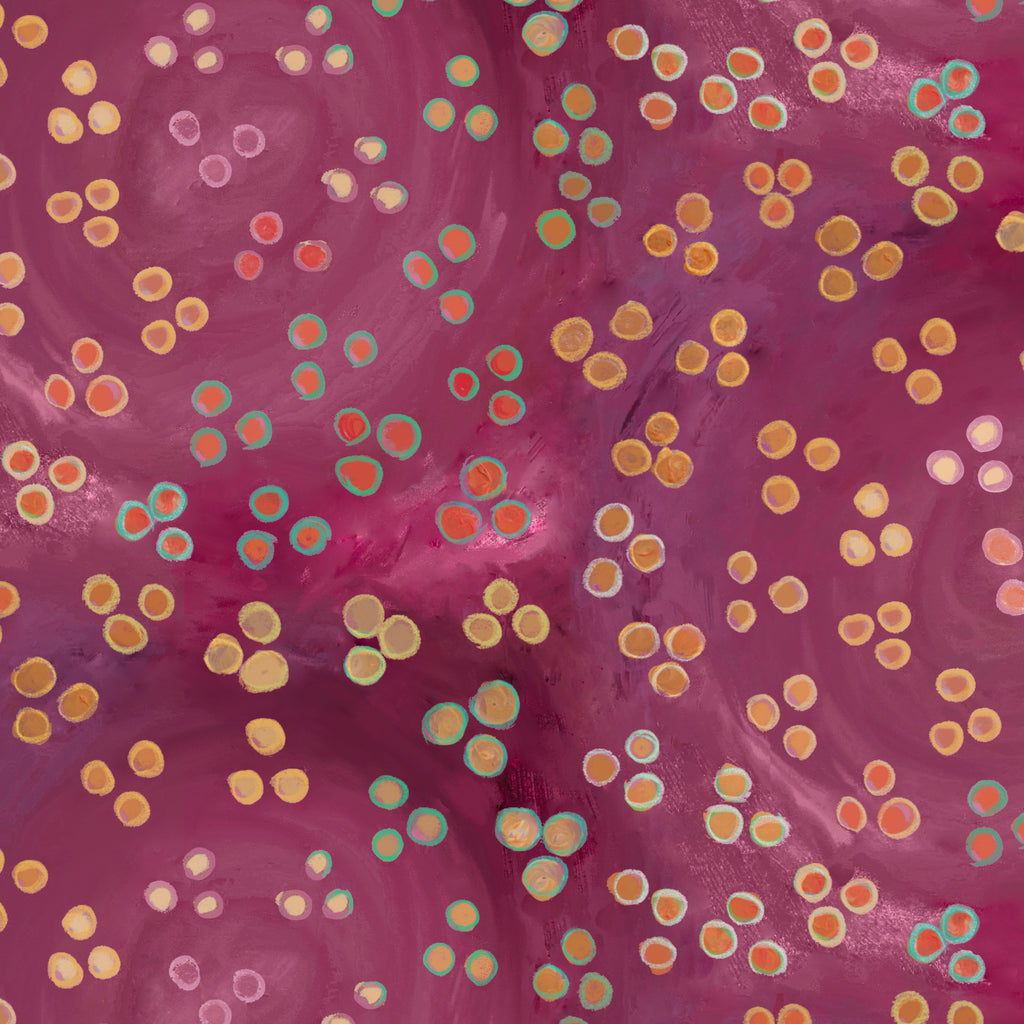 A close-up of a pink and magenta marbled surface with scattered circular spots in yellow, orange, teal, and pale pink.