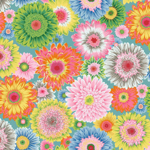 A vibrant seamless floral pattern featuring large, colorful gerbera daisies in shades of pink, yellow, orange, green, blue, and white on a light teal background.