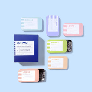 Collection of small, colorful tin boxes with 'SOHMO' branding on a light blue background.