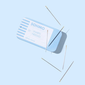 SOHMO sharps needles on a light blue background