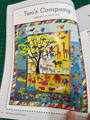 Colorful quilt with animal patterns on a magazine page