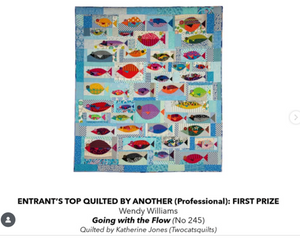 Quilt with colorful fish pattern on a blue background